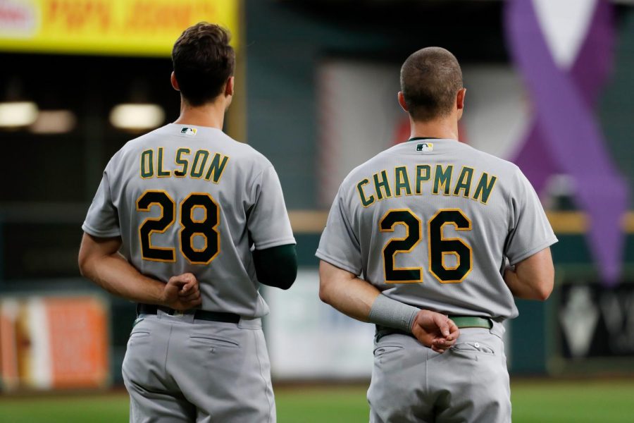 #28 Matt Olson and #26 Matt Chapman look on during the national anthem.