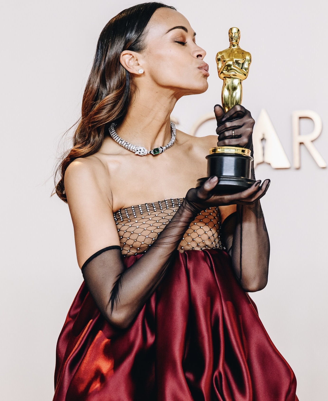 Zoe Saldaña with her Oscar for Best Supporting Actress for Emilia Perez, a Netflix Film