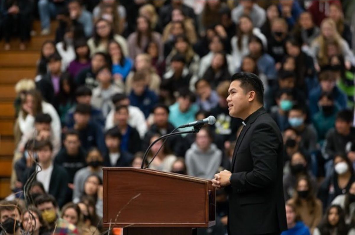 Father Francis speaking at an assembly.