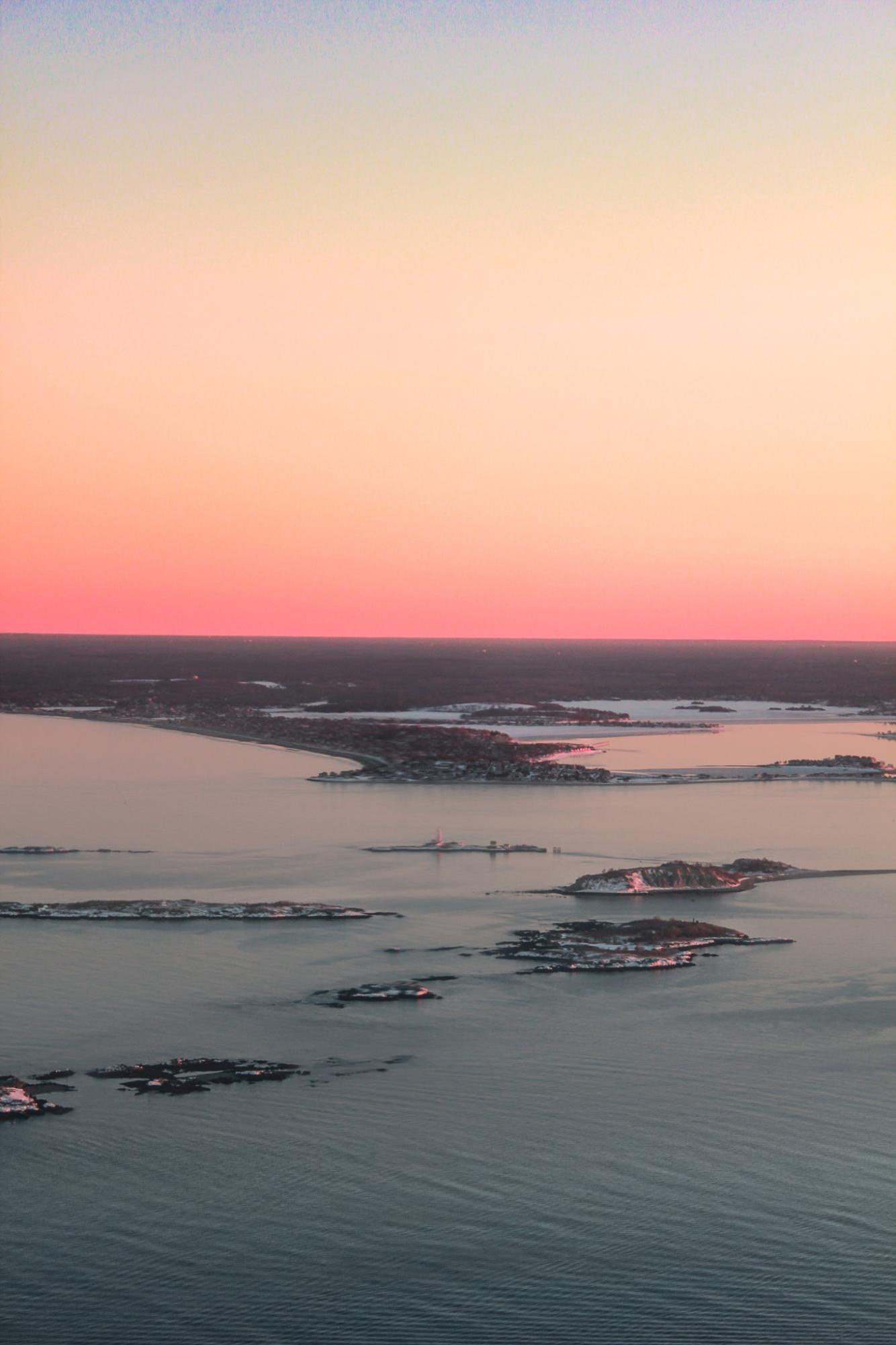 Amidst the turbulence of a landing flight, the sunset creates a stillness embracing the sea.