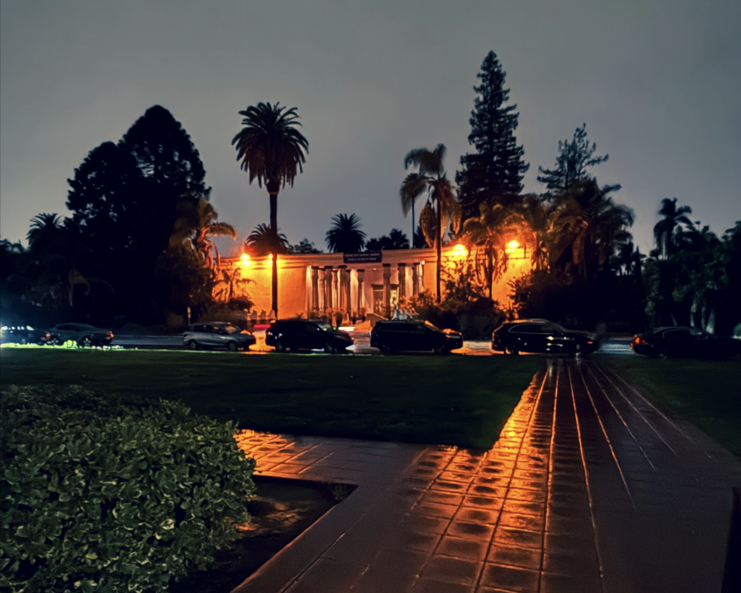 A photo of a theatre at night while it was raining. The reflections made the light look really cool. I shifted the tint to be more green so that it would further contrast and bring out the orange light, which is like a beacon in the dark.