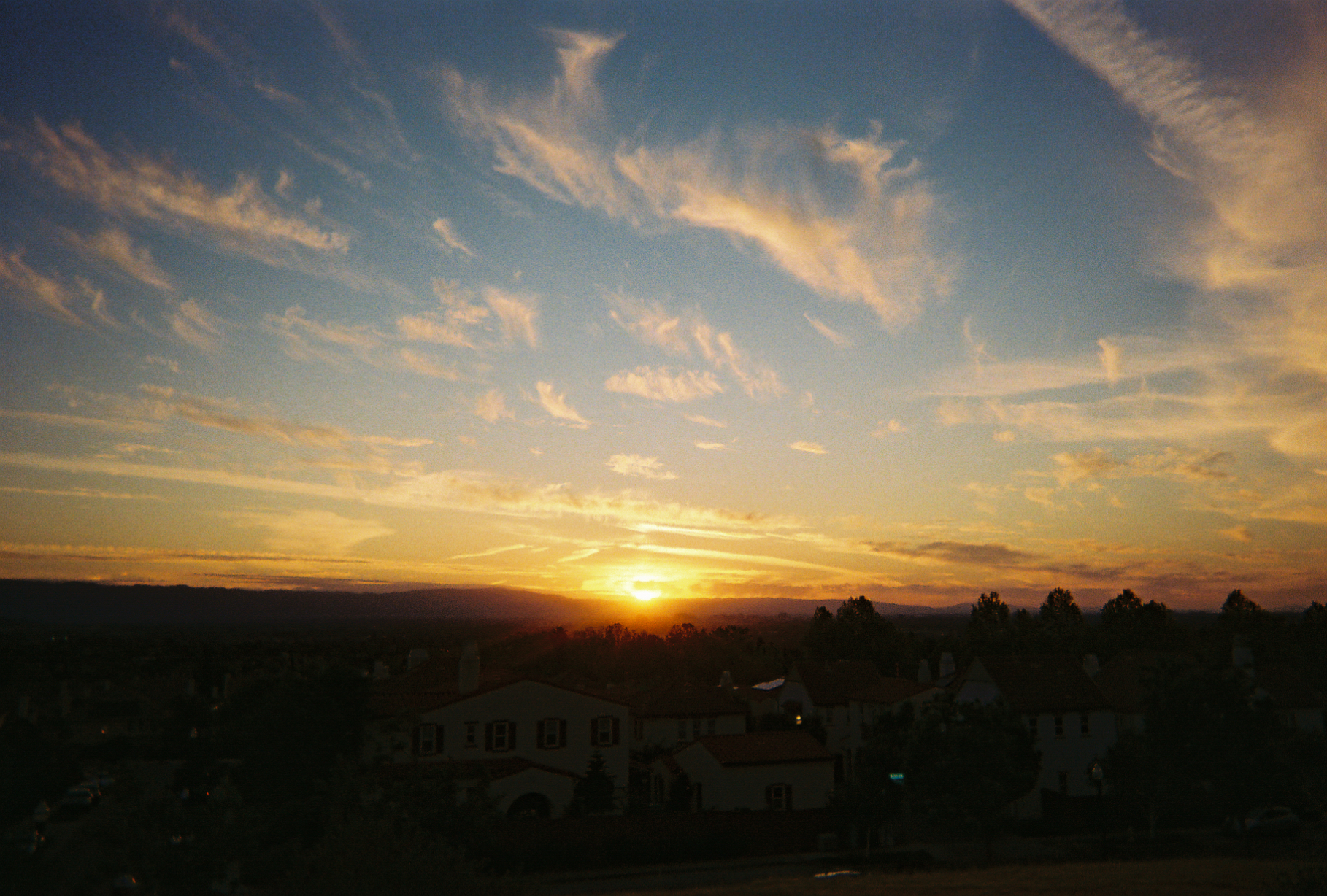 The sun carves houses and the clouds apart.